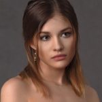 woman looking towards her left side, with earring